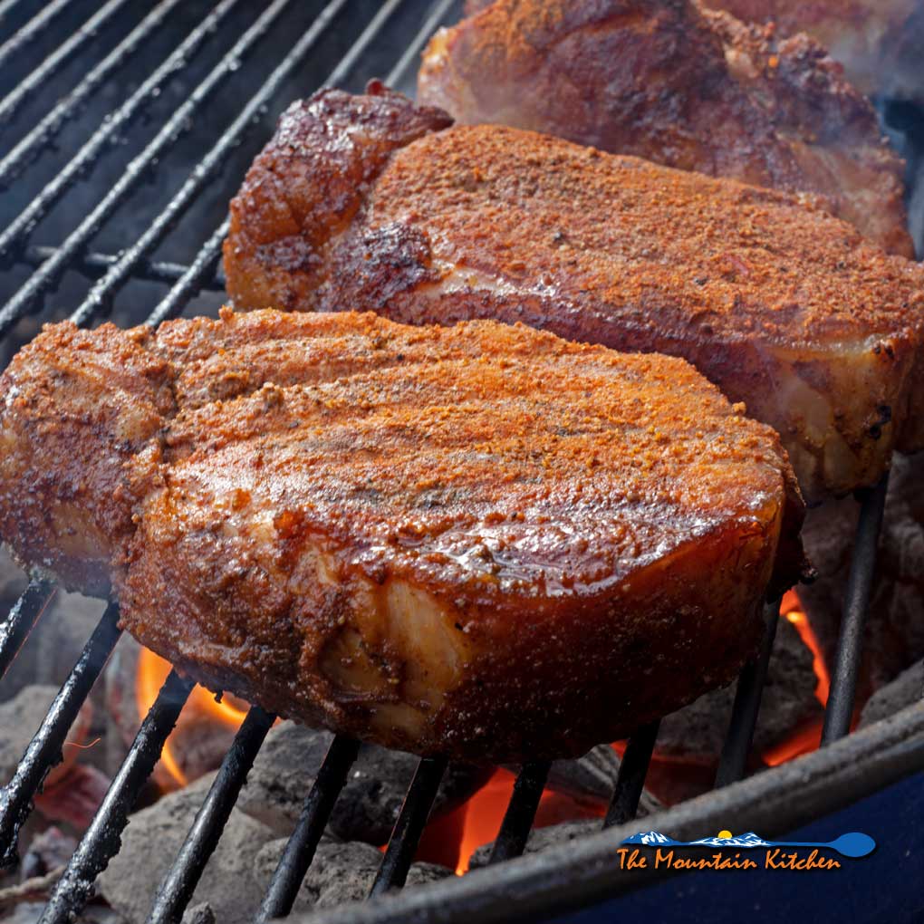 smoked pork chops searing on grill
