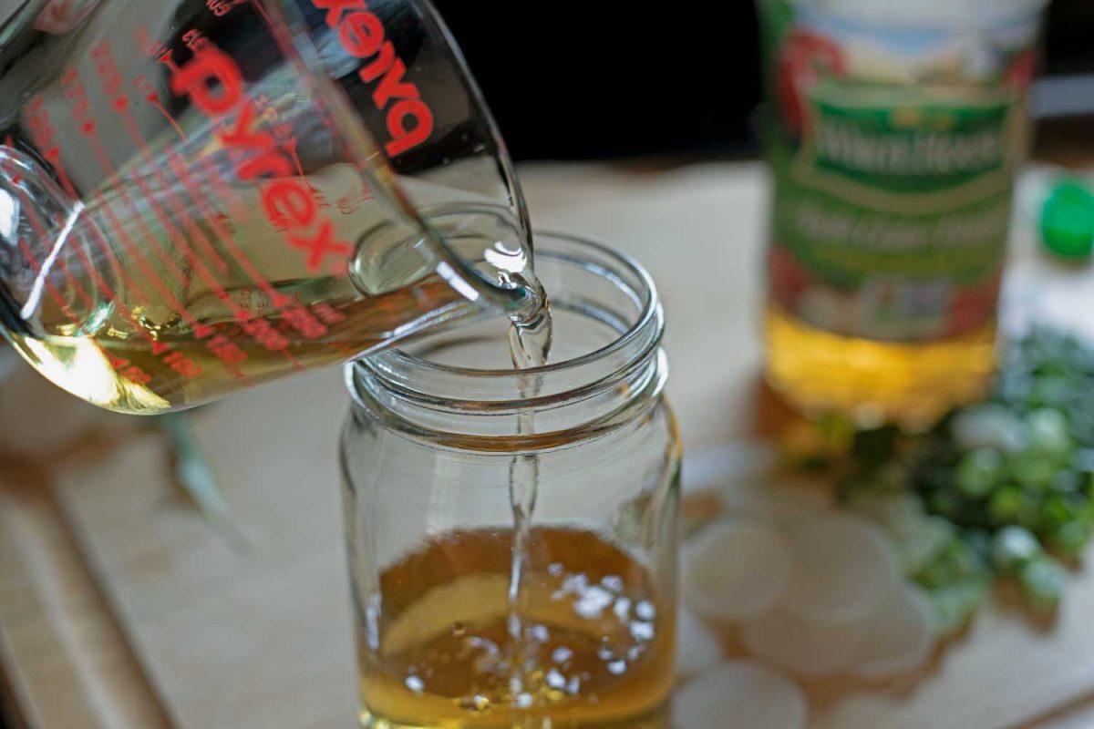 pouring vinegar into a jar