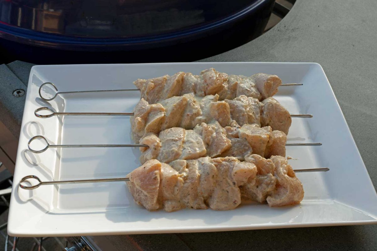 raw marinated and skewered Greek chicken on platter