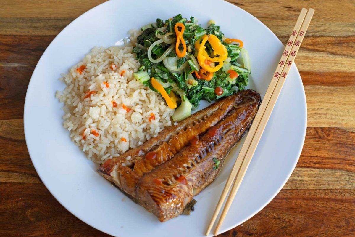 soy-glazed cod on plate with bok choy, rice and chop sticks