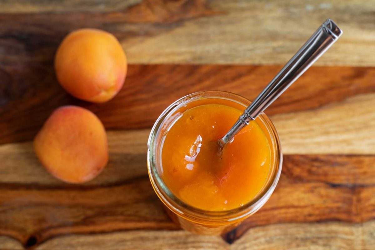apricot jam in jar with spoon