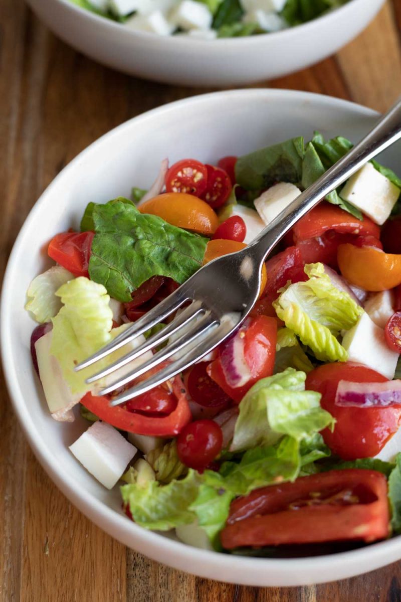 marinated tomato salad in bowl with fork