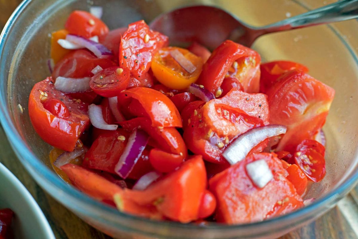 marinating tomatoes and onions in bowl