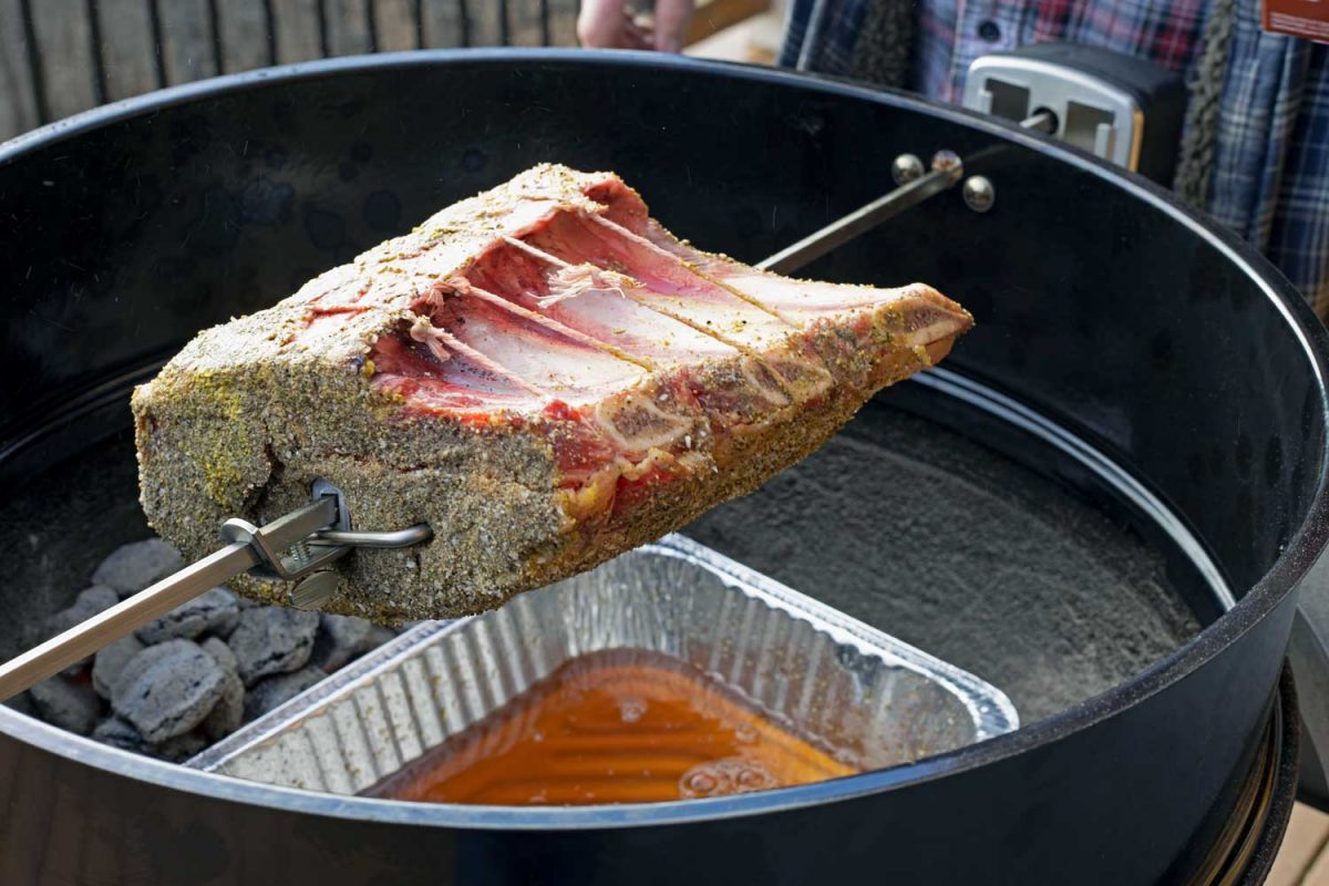 raw rib roast on rotisserie