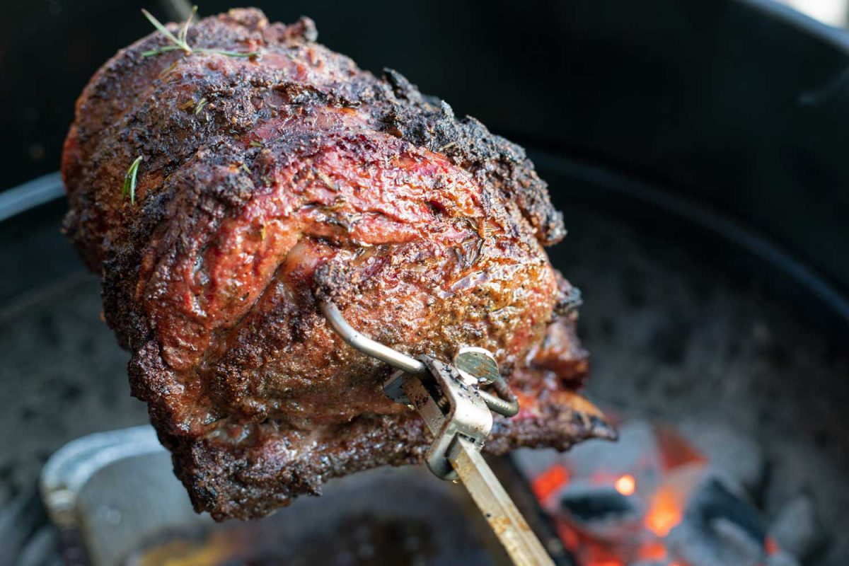 standing prime rib roast on rotisserie