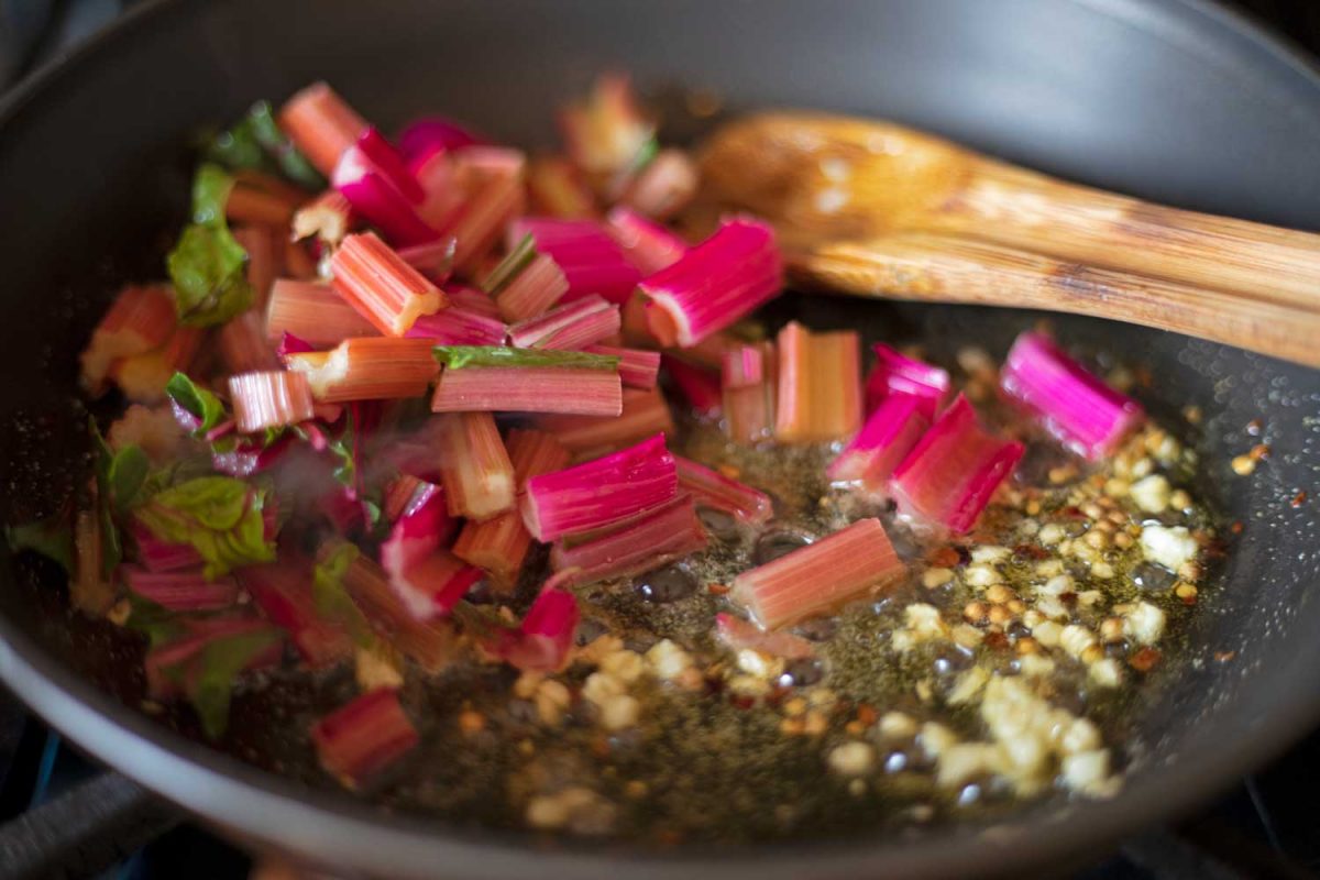 chard stems in skillet with seasoned oil