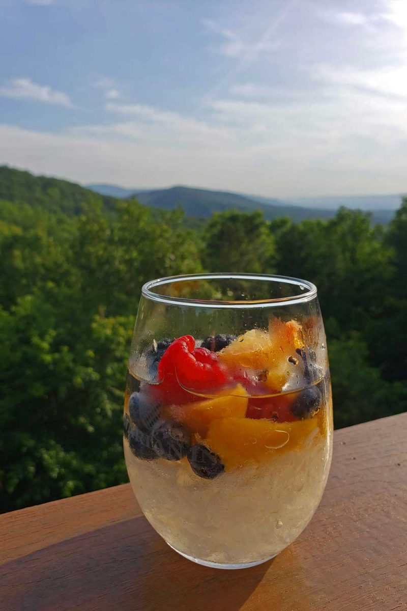 glass of white sangria with mountain view