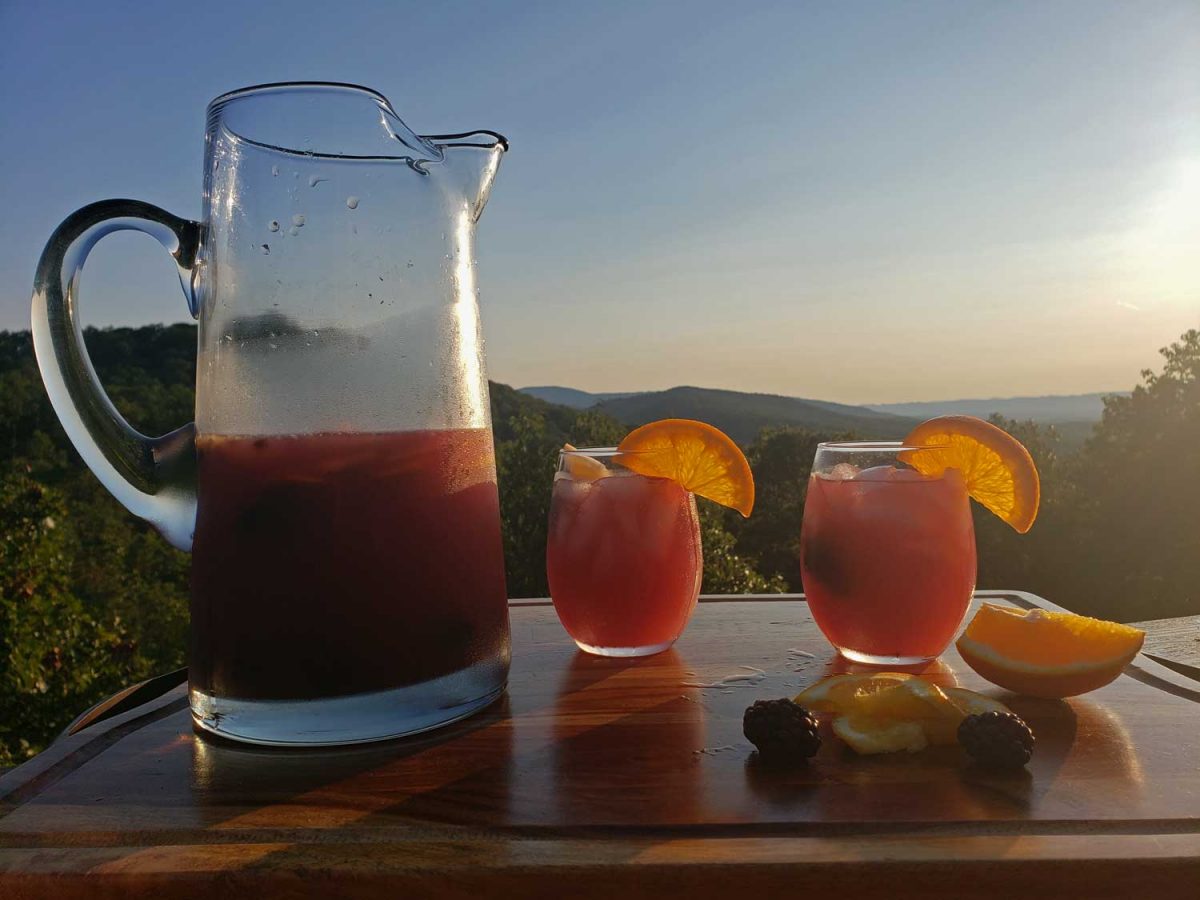 a pitcher and two glasses of sangria with mountain view