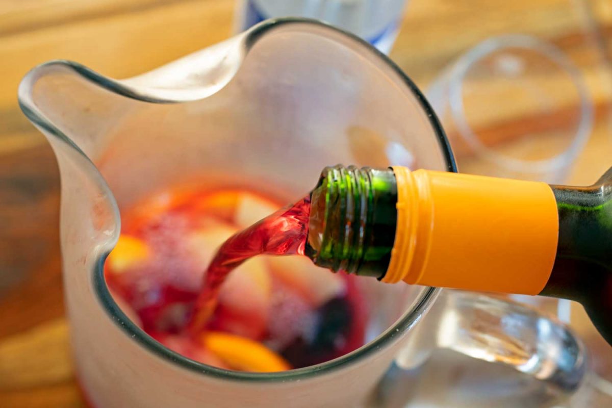 wine pouring into glass pitcher