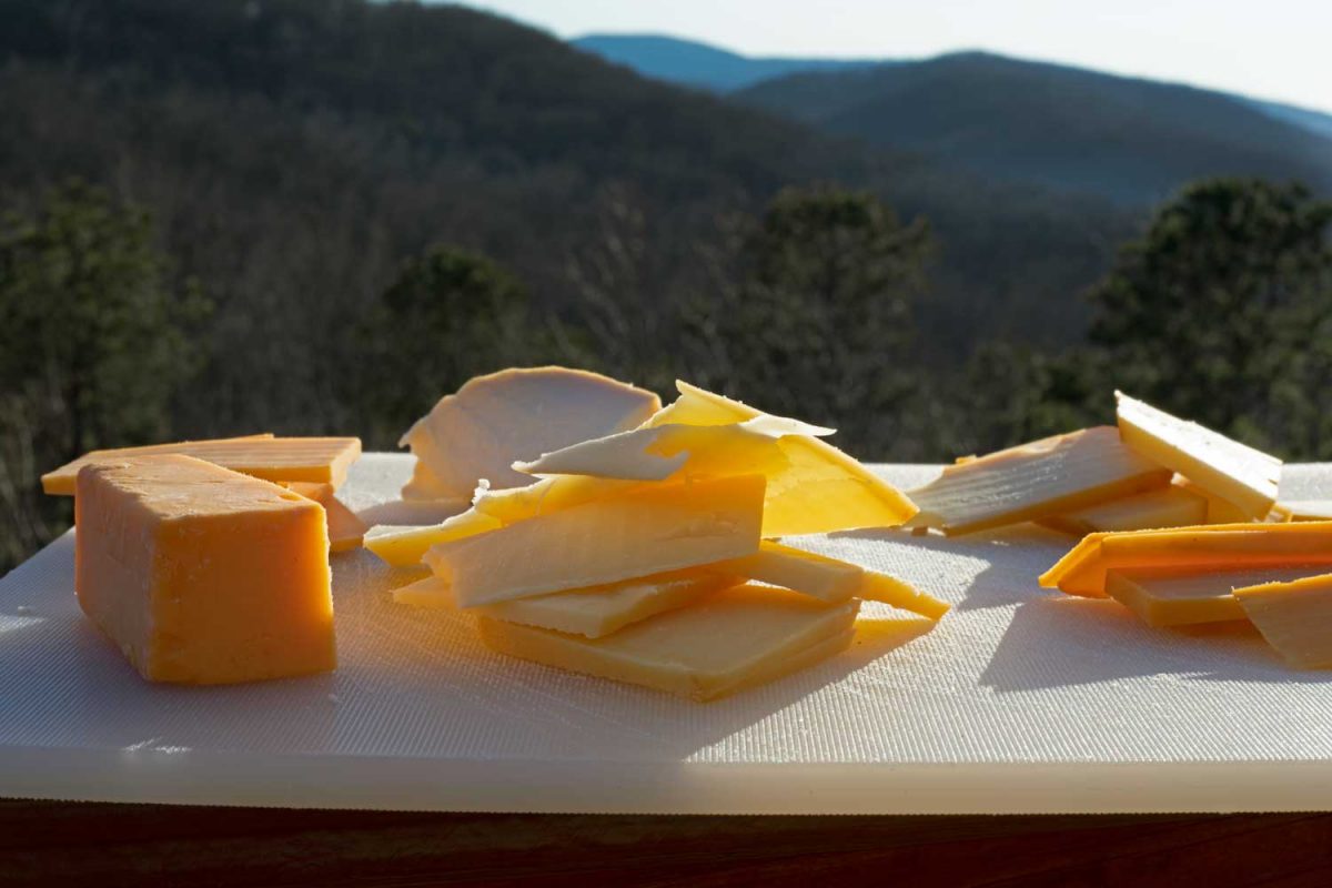 slices of smoked cheese on cutting board