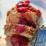 Pork tenderloin with cranberry sauce sliced on plate