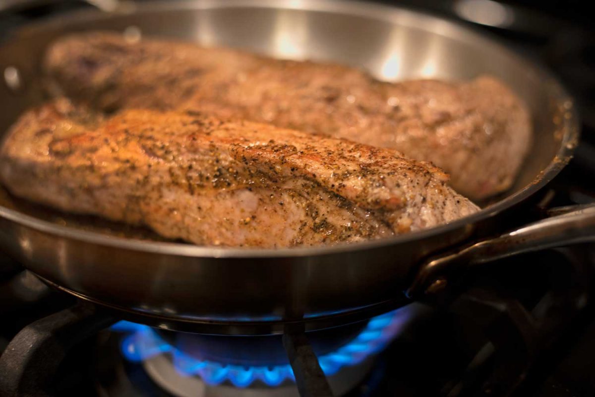 pork searing in skillet