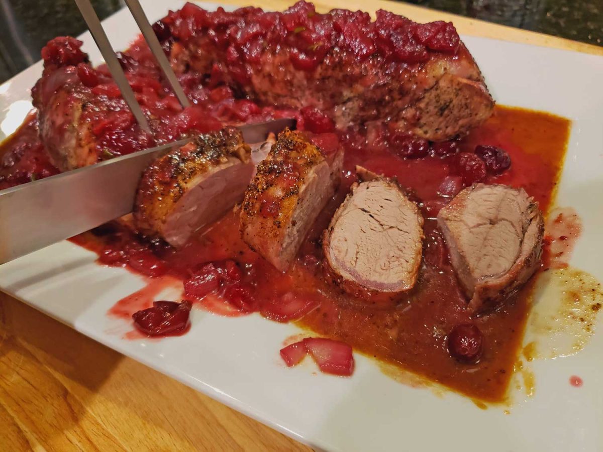 pork tenderloin with cranberry sauce on platter
