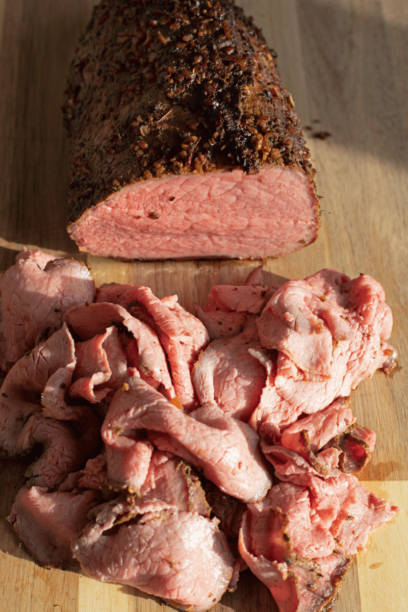 sliced roast beef on cutting board