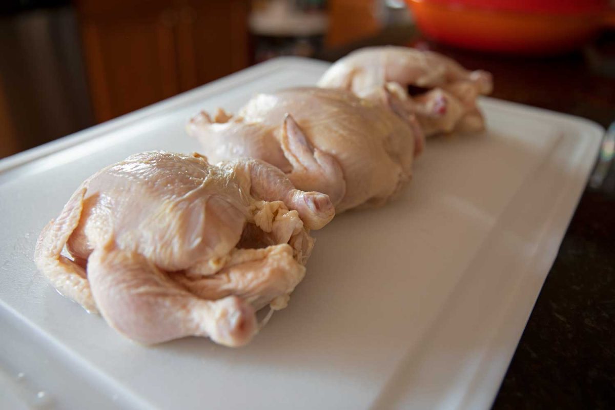 raw Cornish game hens on cutting board