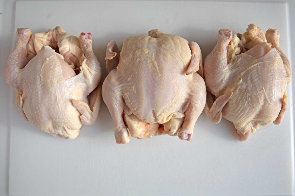 Raw Cornish Game Hens on cutting board