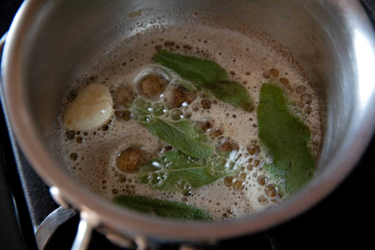garlic and sage inside saucepan with brown butter