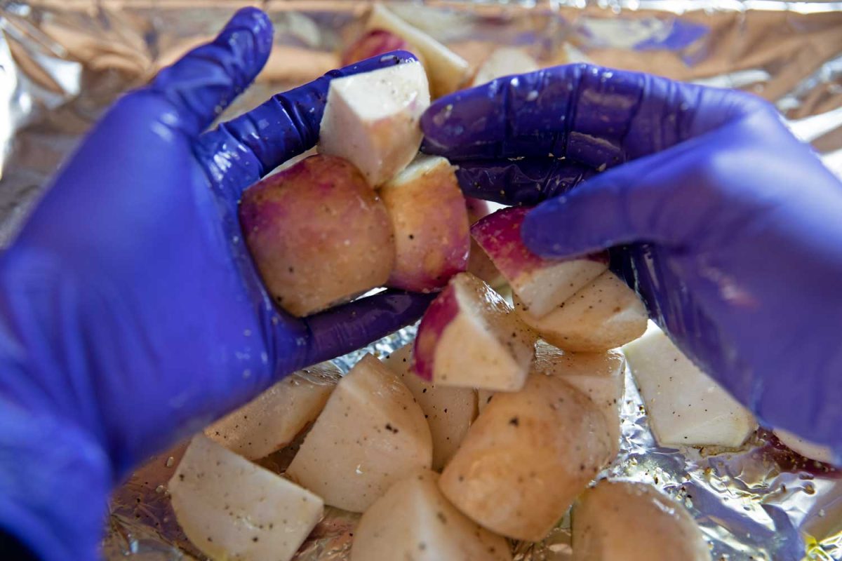 tossing turnips with gloved hands