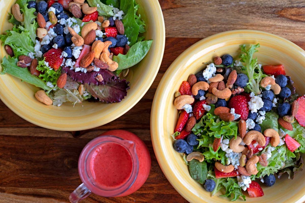 spring mixed berry salad in bowls with strawberry vinaigrette