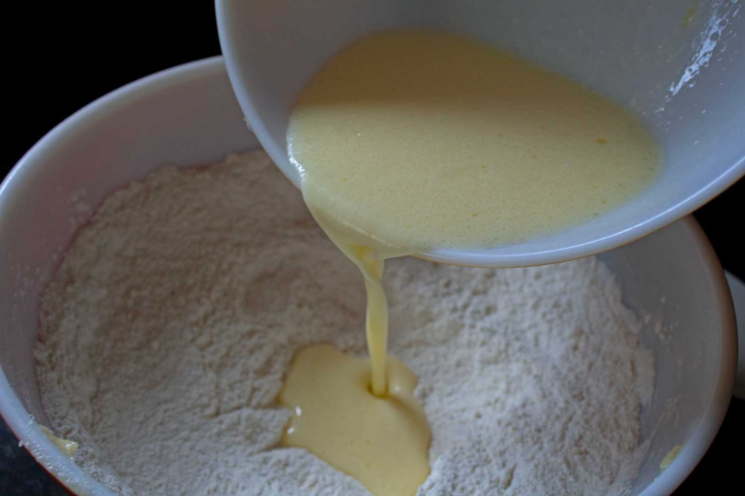 pouring wet mixture into dry mixture