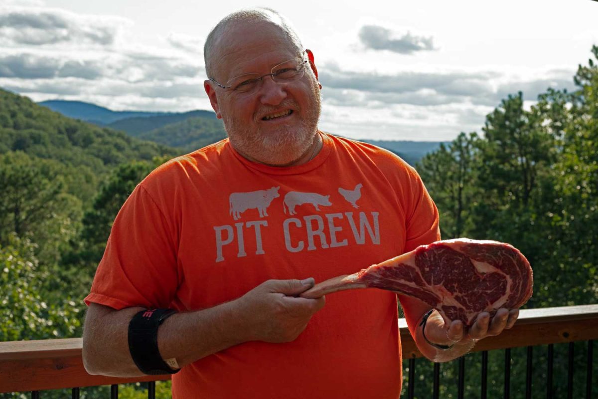David holding Tomahawk steak
