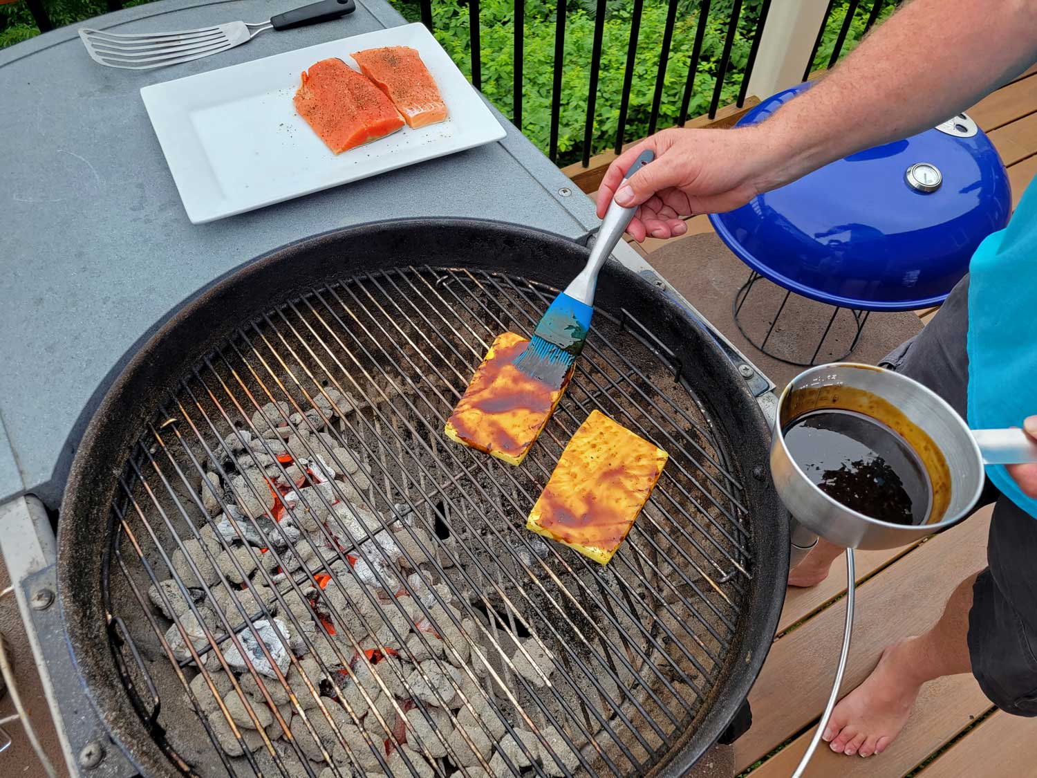 brushing teriyaki sauce onto pineapple planks