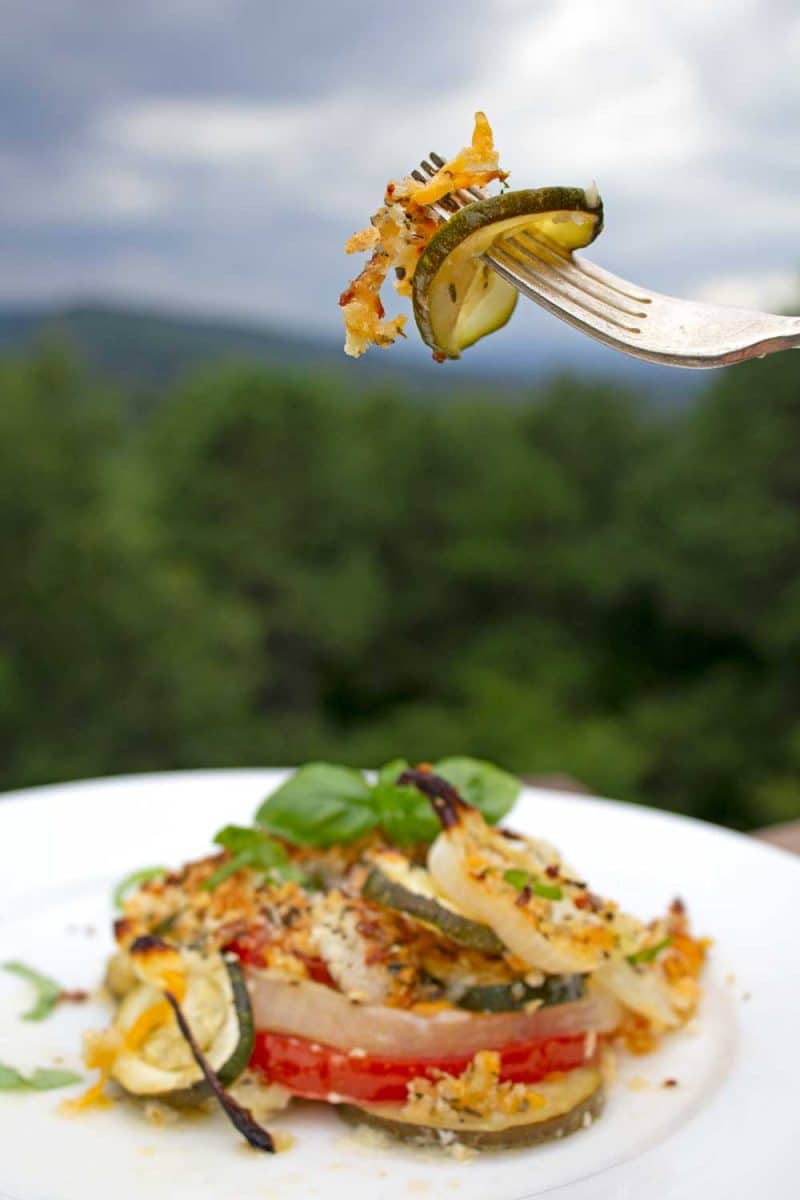 fork full of zucchini casserole over plate