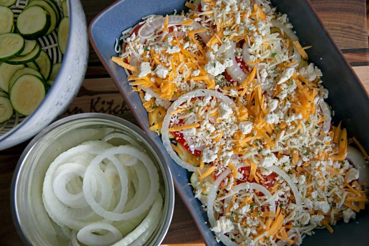 layers of vegetables and cheese in casserole dish