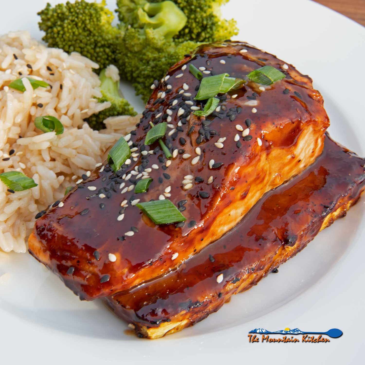 pineapple grilled salmon on plate with rice and broccoli