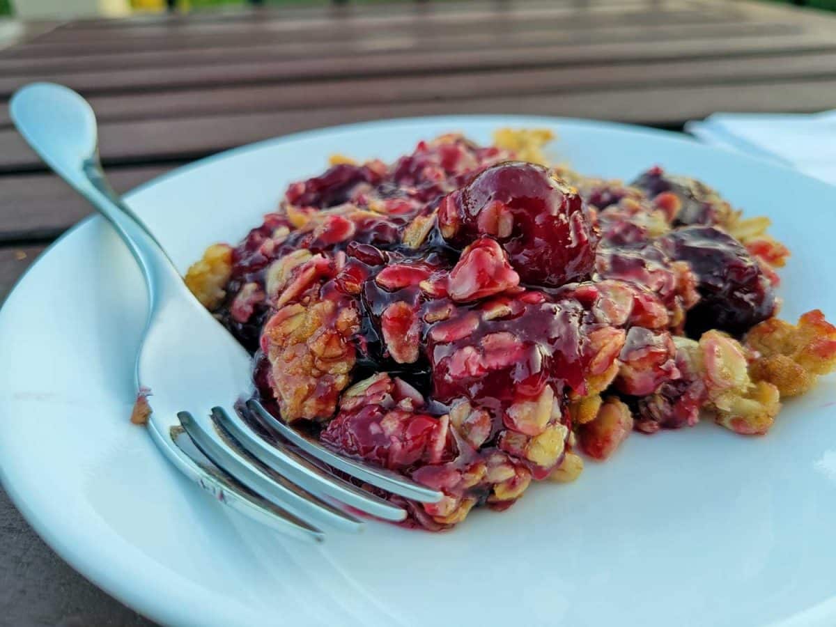 cherry crisp on plate with fork