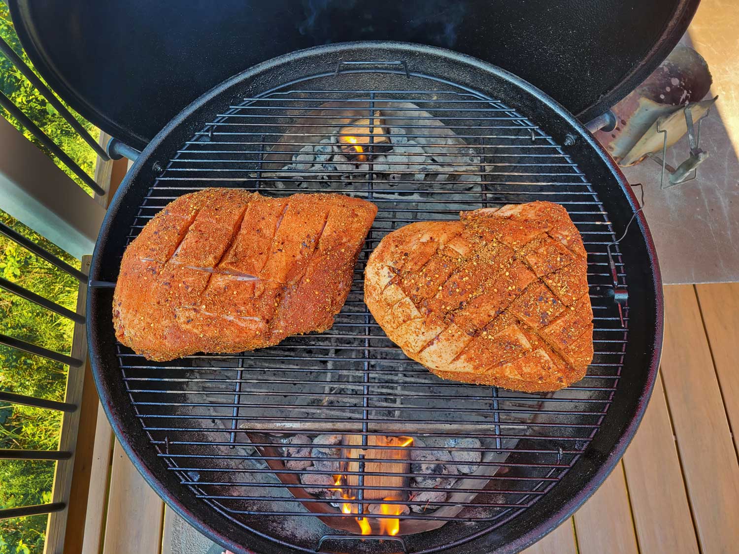 pork shoulder and pork butt smoking on grill