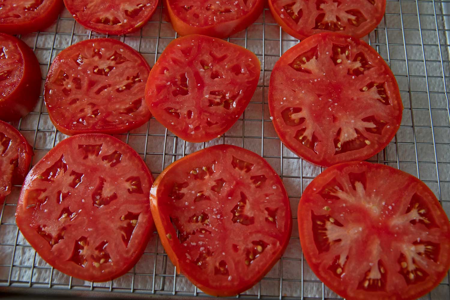 salted tomato slices on rack