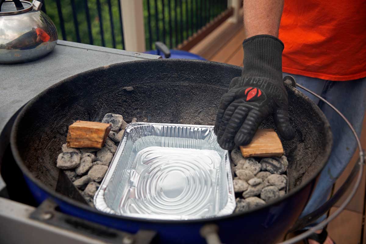 placing cherry wood chunks on the coals