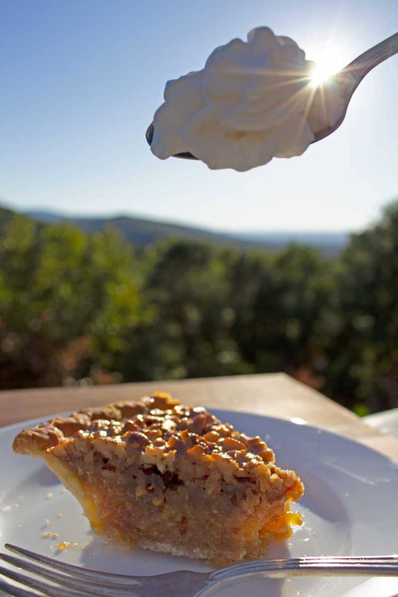 dollop of whipped cream over pecan pie