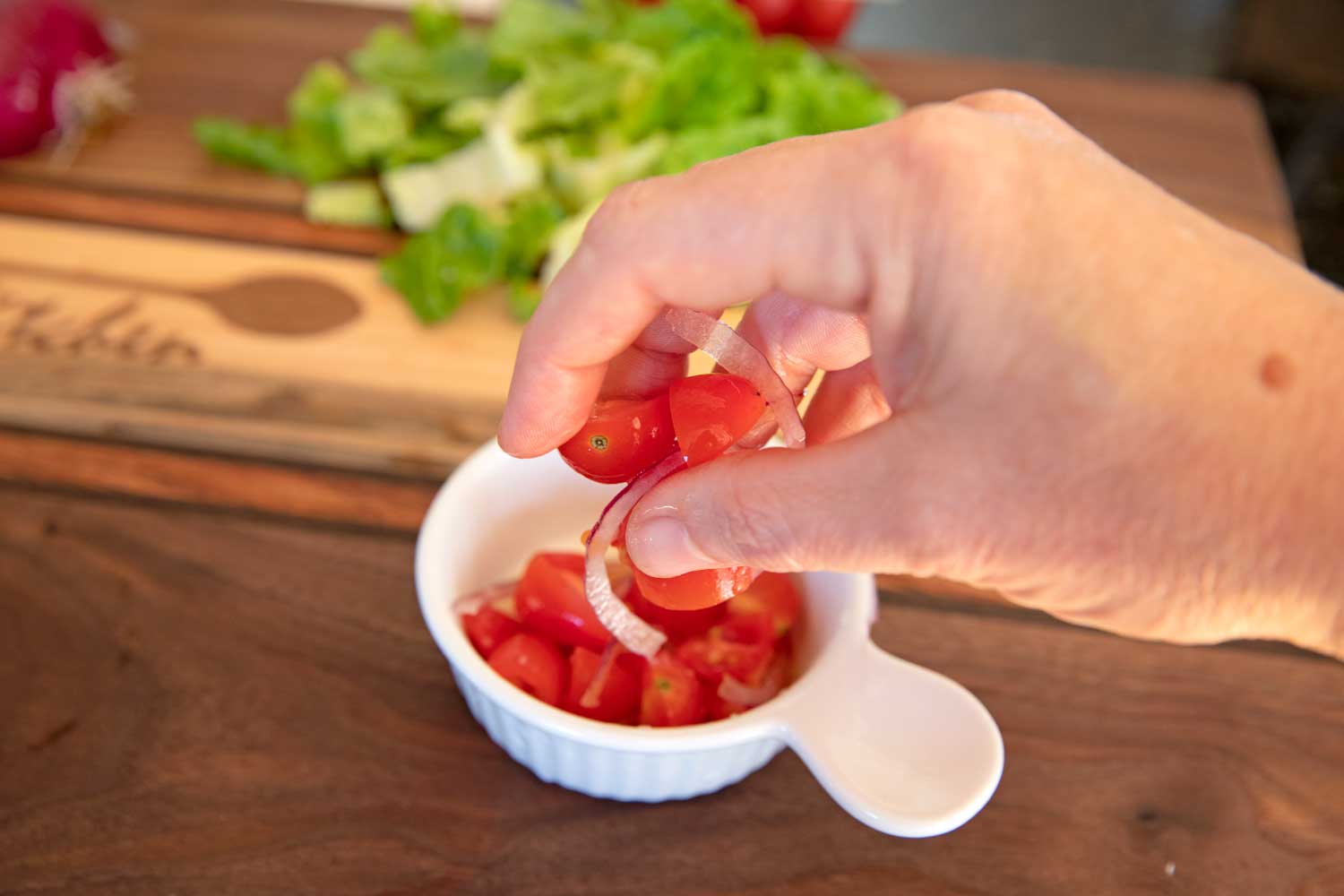 tossing tomatoes and onion with salt