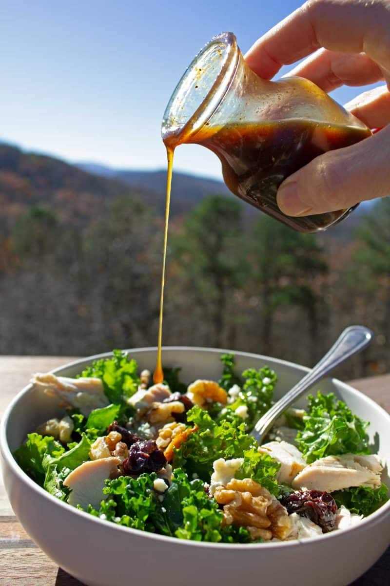 pouring dressing over salad