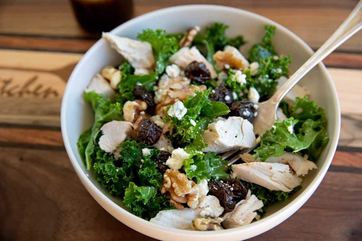 kale salad in bowl with spoon