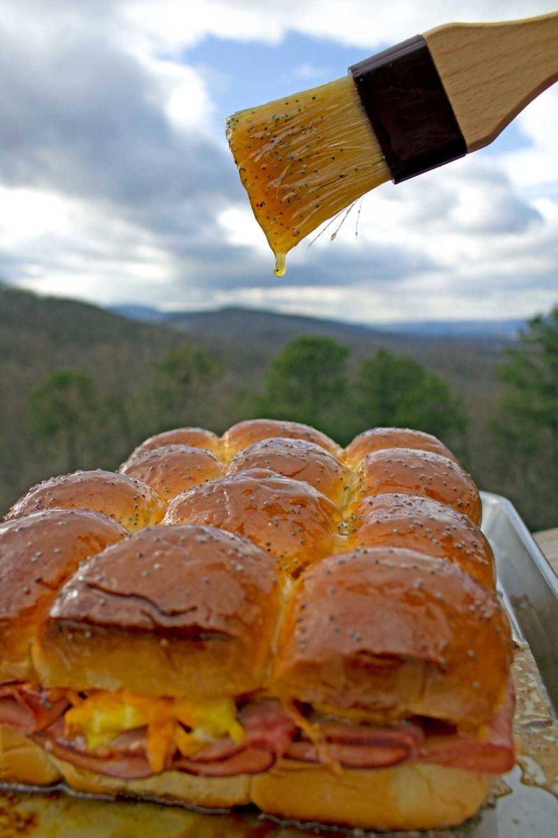 honey butter dripping off brush onto breakfast sliders