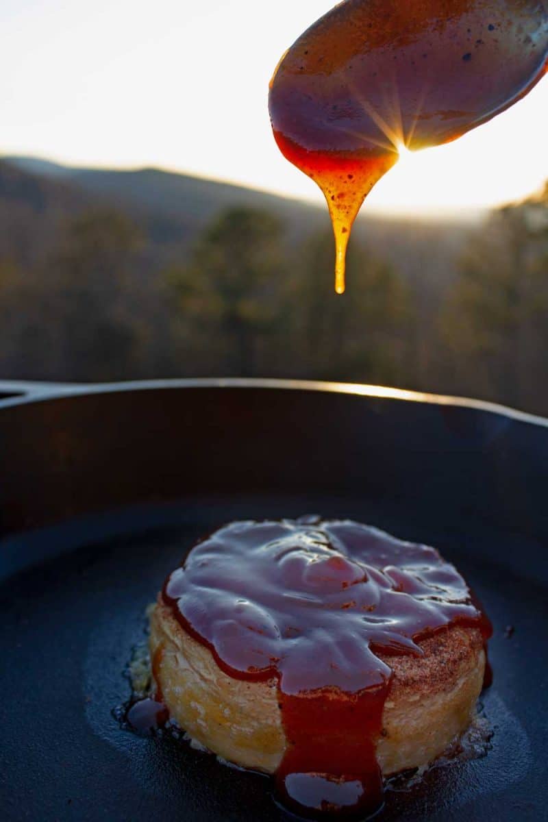 barbecue sauce dripping onto cheese from spoon