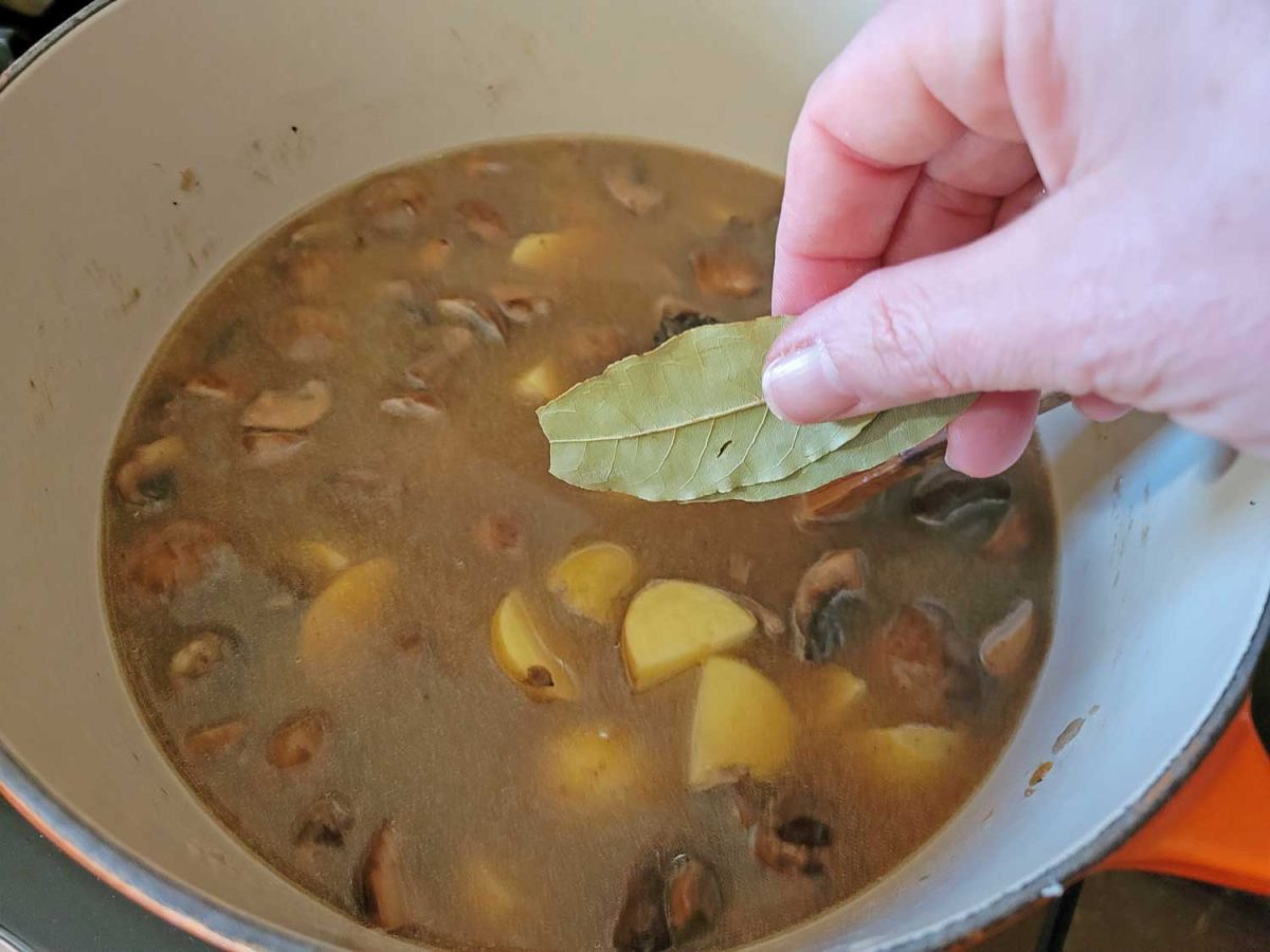 adding bay leaves to pot
