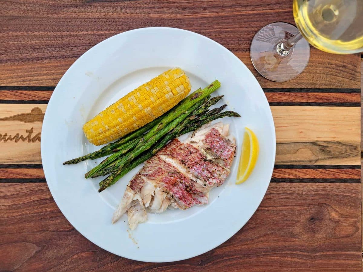 plate of red snapper, corn and asparagus