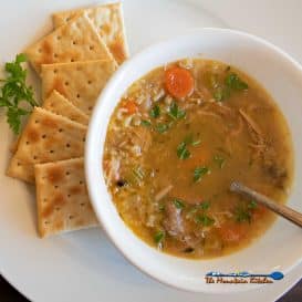 bowl of leftover turkey soup with crackers