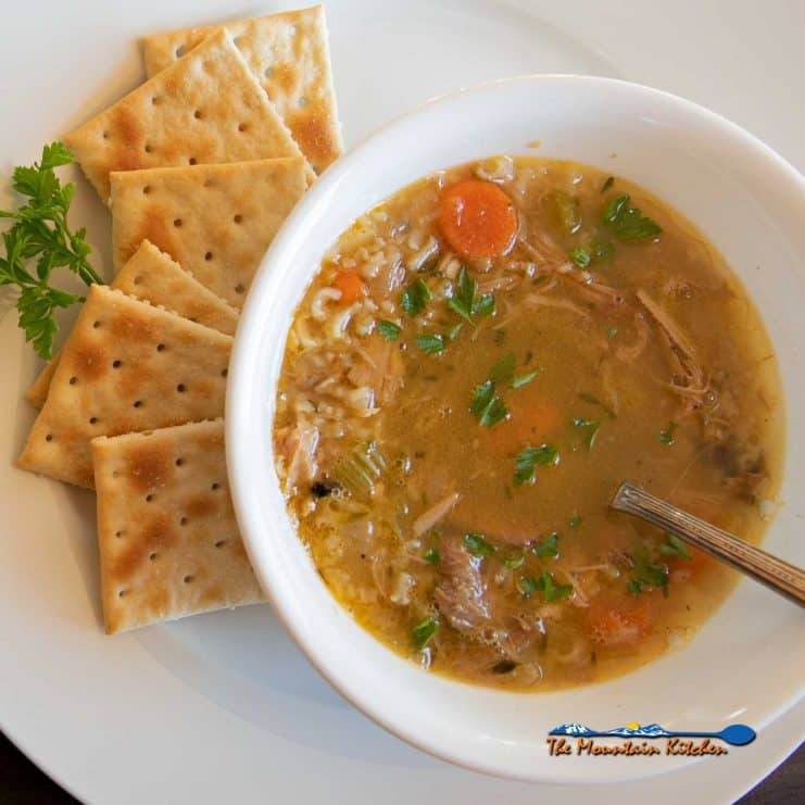 bowl of leftover turkey soup with crackers