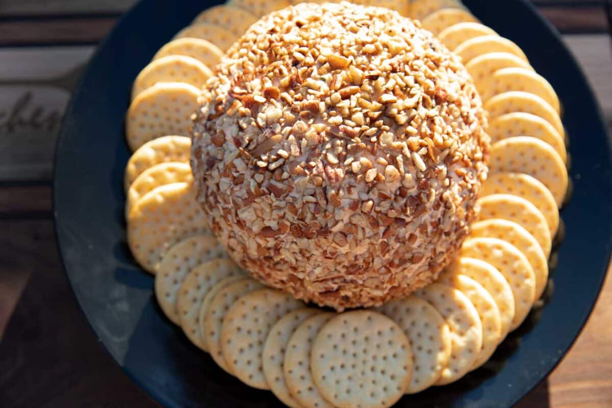smoked cheese ball on plate with crackers