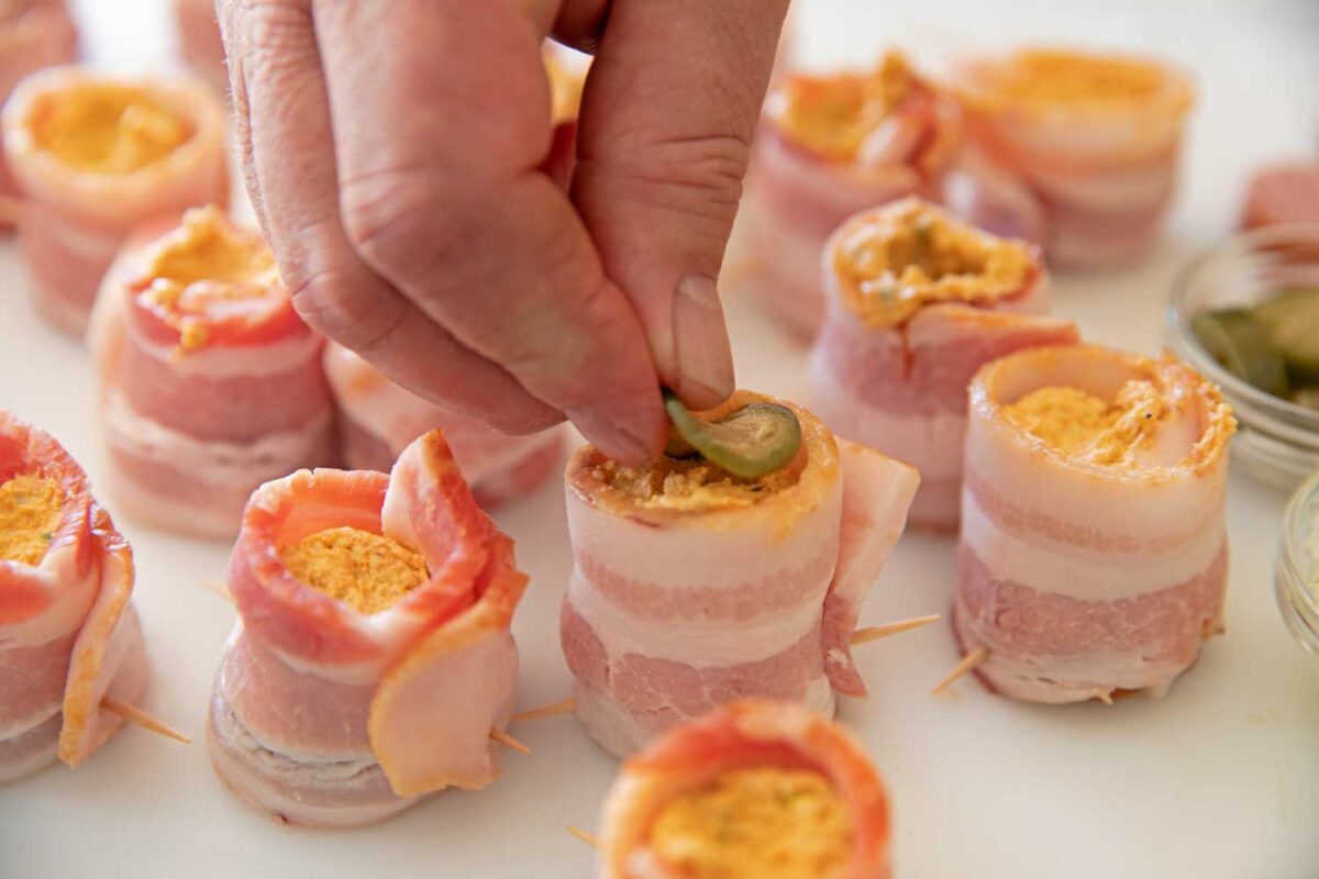 placing jalapeno slice on pig shot
