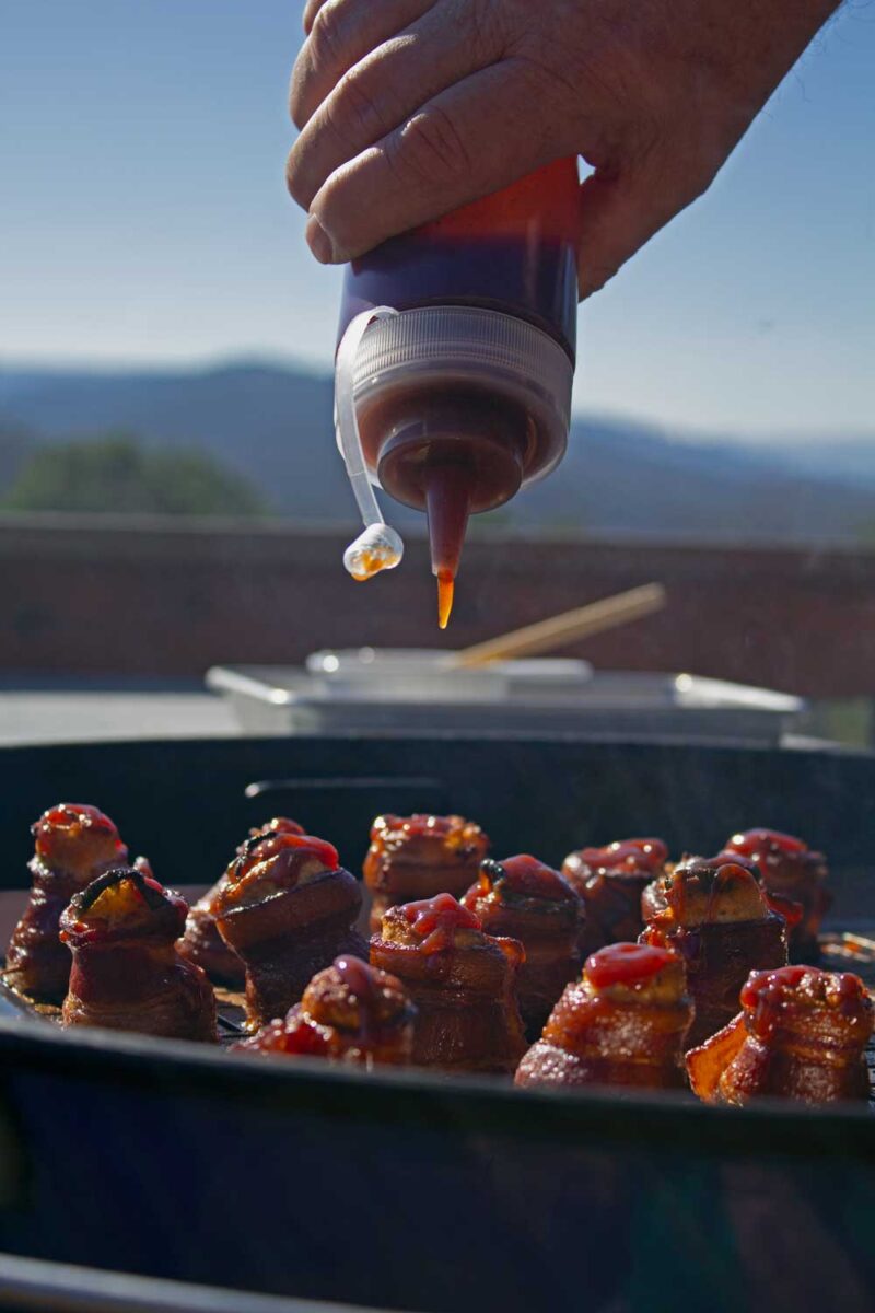 putting barbecue sauce on the pig shots