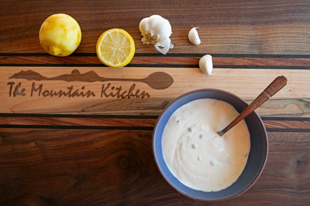 bowl of lemon aioli with garlic and lemon