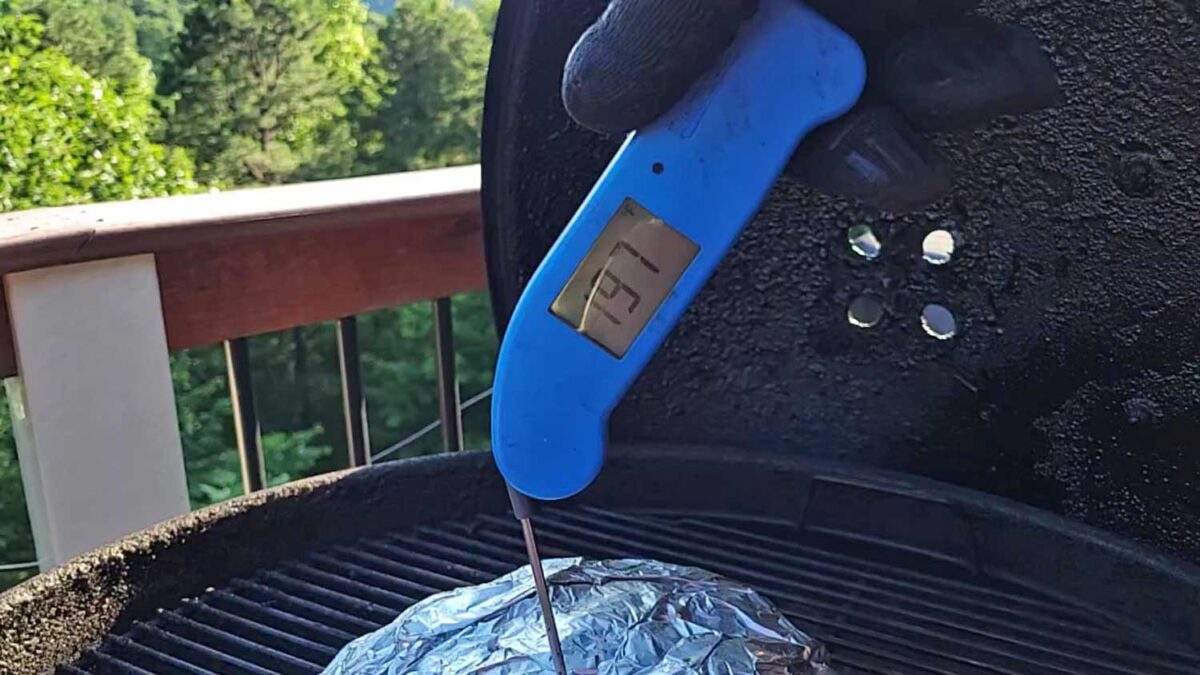 instant-read thermometer reading pork internal temp