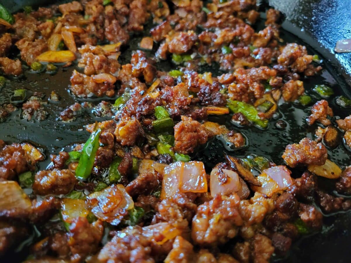 chorizo in skillet with peppers and onions