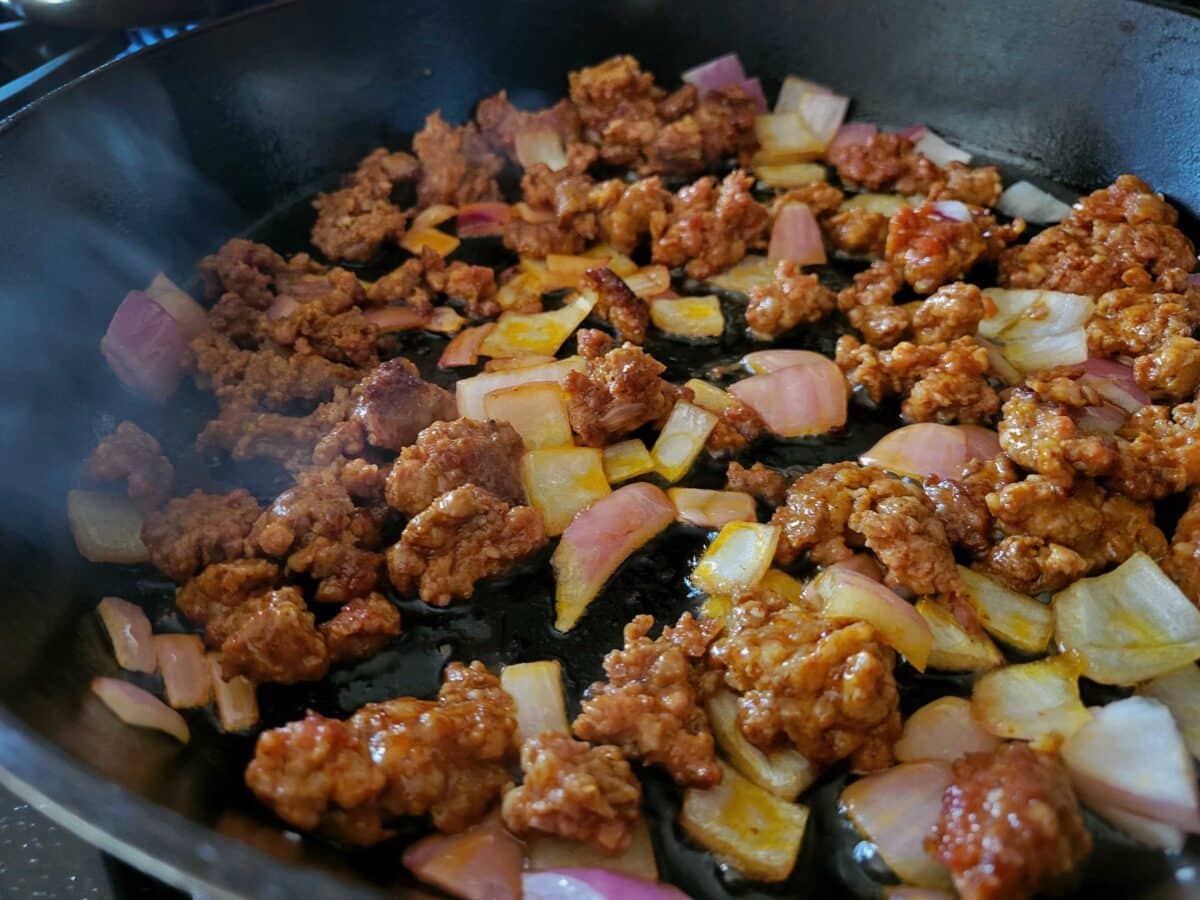 chorizo and onions cooking in skillet